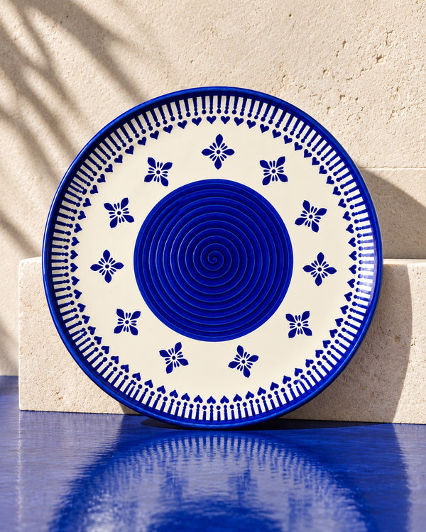Heritage Blue Ceramic Quarter Plates (Set of 2) one plate standing on a steel ledge with its reflection (AI-generated styling image)