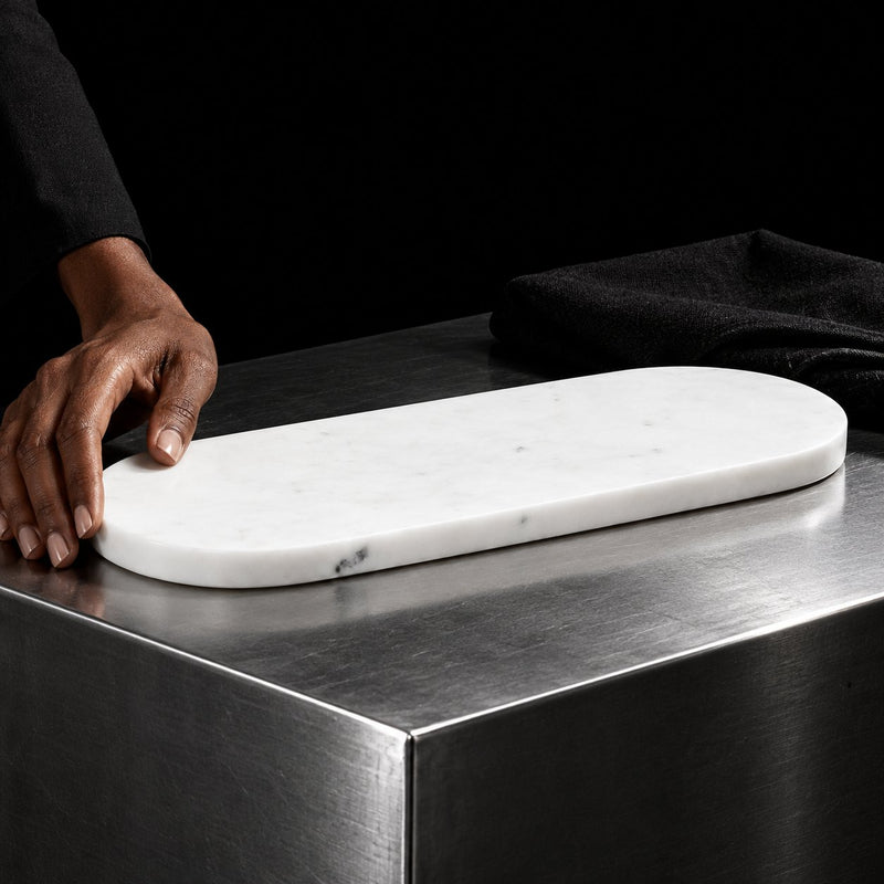 White marble serving tray on a steel counter