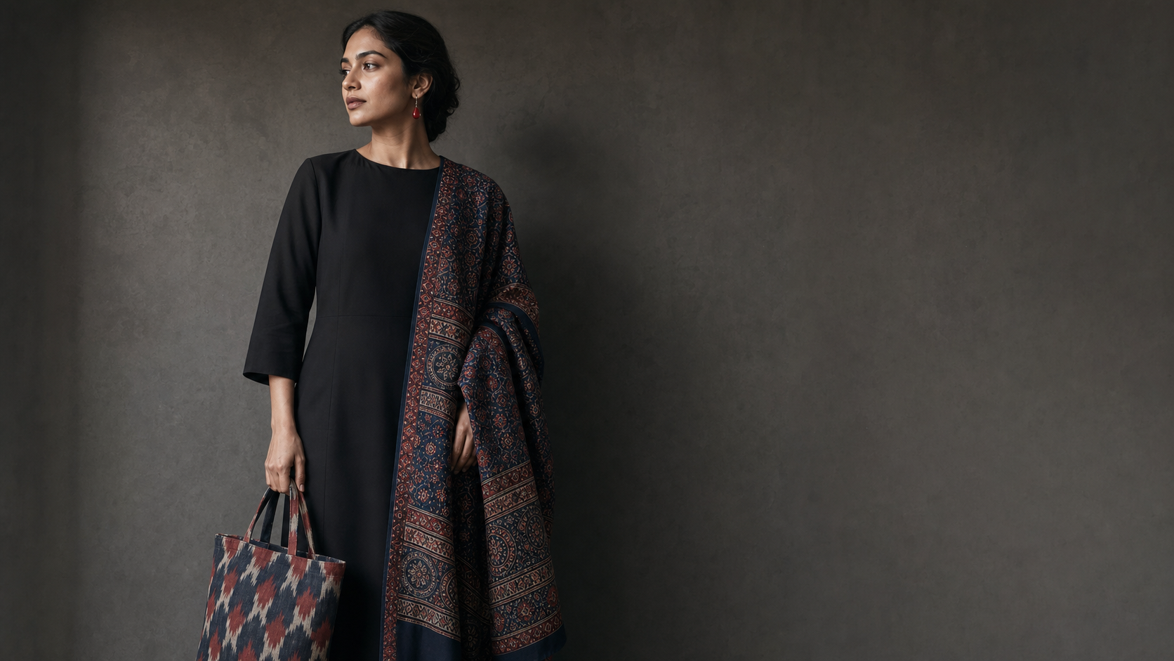 A plain black dress styled with a handcrafted indigo Ajrakh block-print stole and Indian craft accessories — House of Falguni