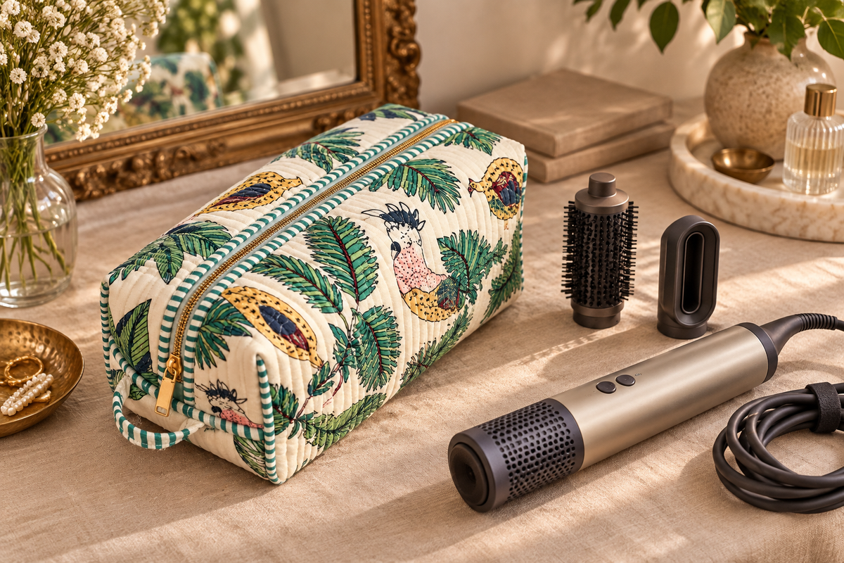 Vaan quilted hair tool bag beside a cooled styler, detached attachments and a coiled cable.