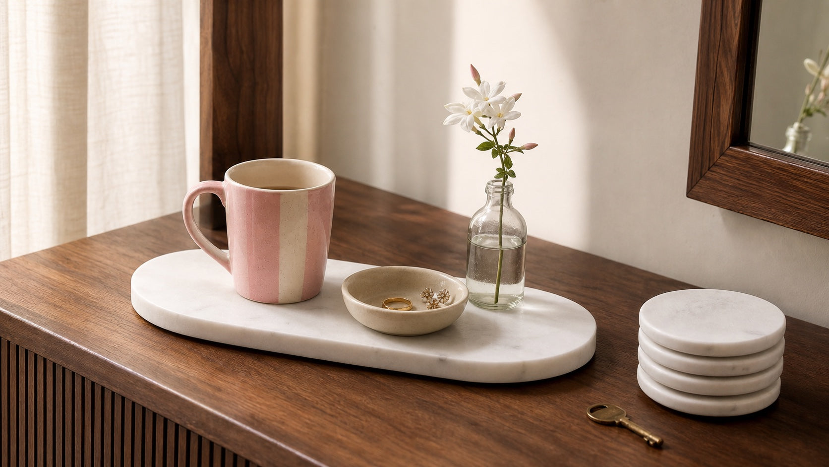 Blush ceramic mug, jewellery dish and jasmine vase styled on an oval white marble tray