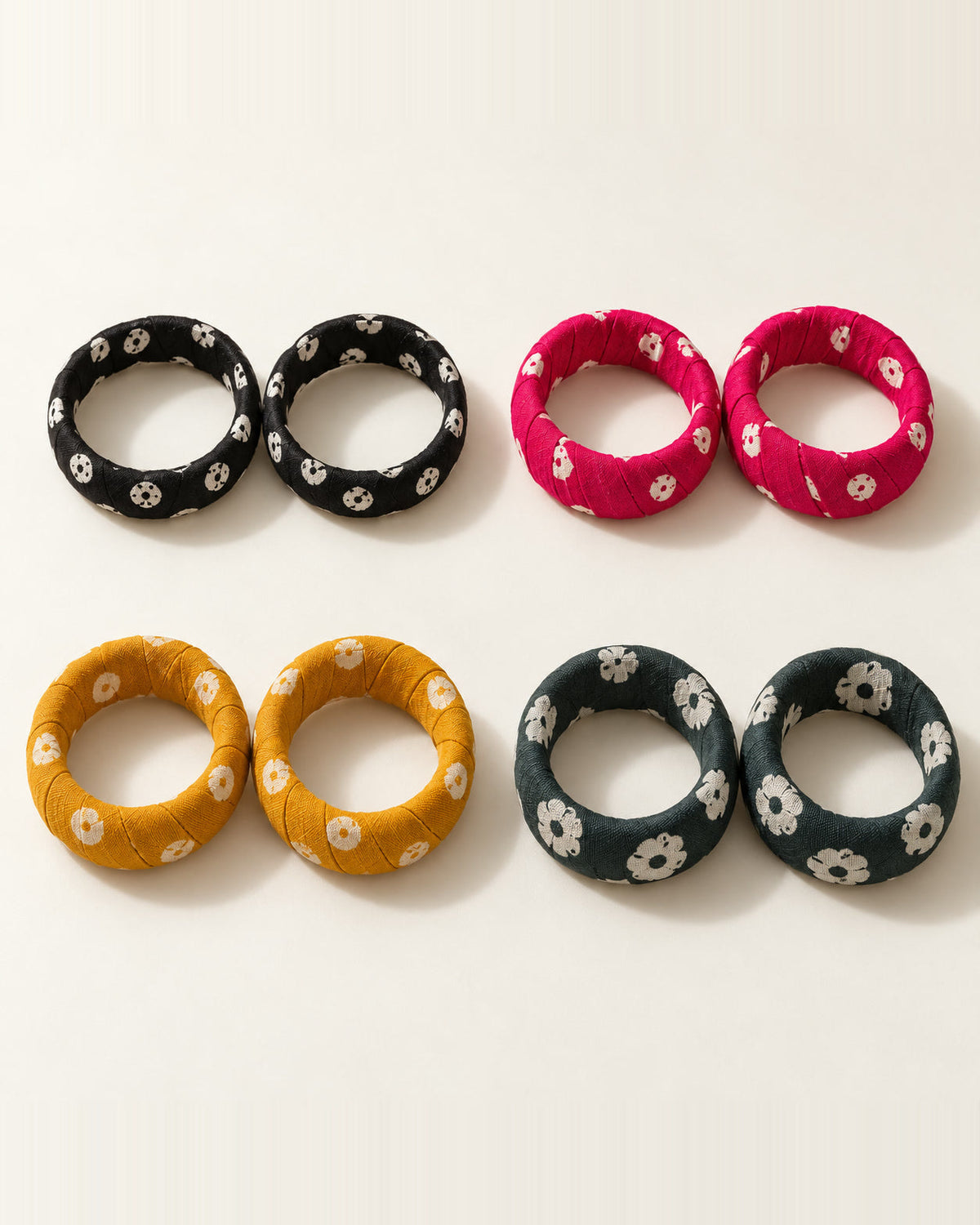 Four pairs of printed fabric bangles laid flat, showing their inside diameter