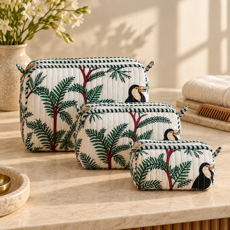 Angan quilted makeup pouch set of three in graduated sizes with green foliage and toucan print.