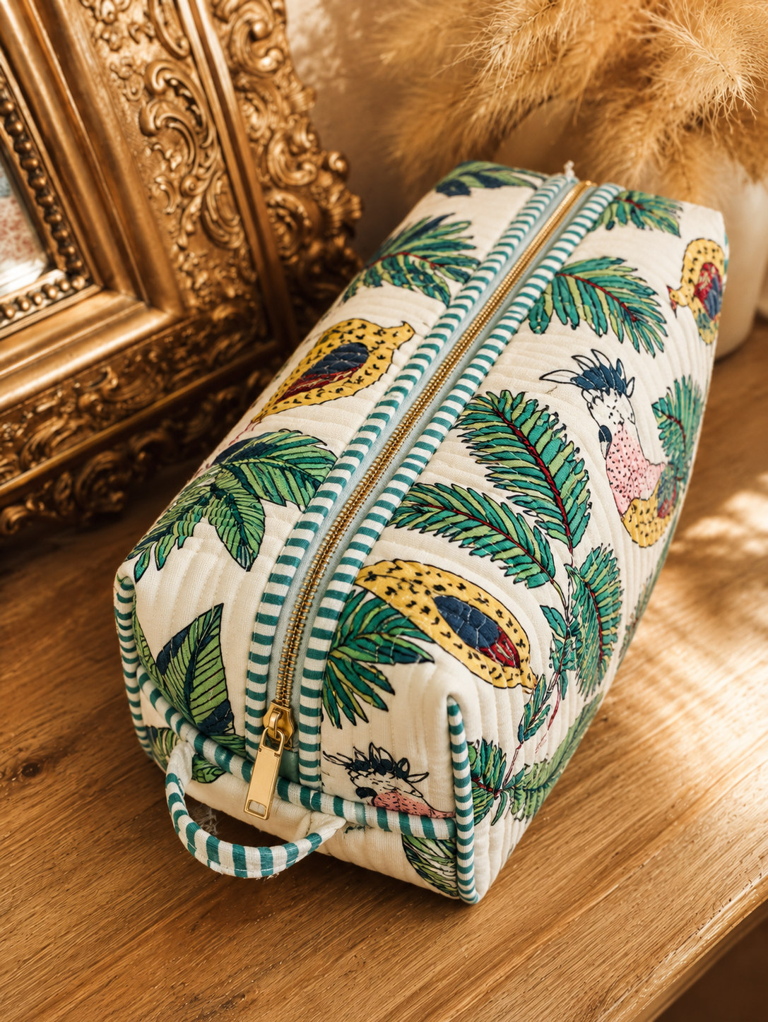 Vaan quilted hair tool bag in a cockatoo and palm print on cream, zipped shut