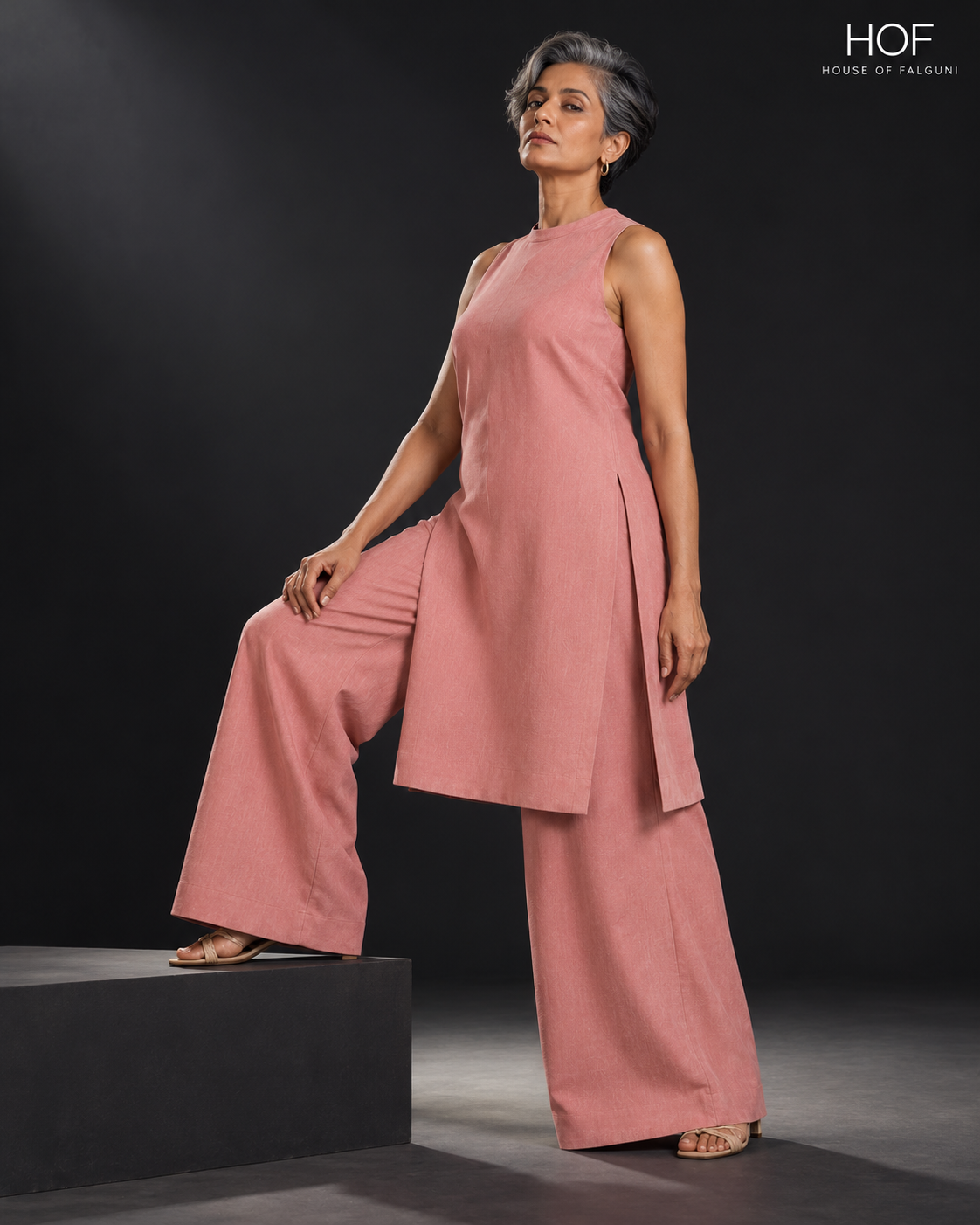 Gulshan Halter Neck Ethnic Co-ord Set in dusty pink, worn by a grey-haired model with one foot on a black step
