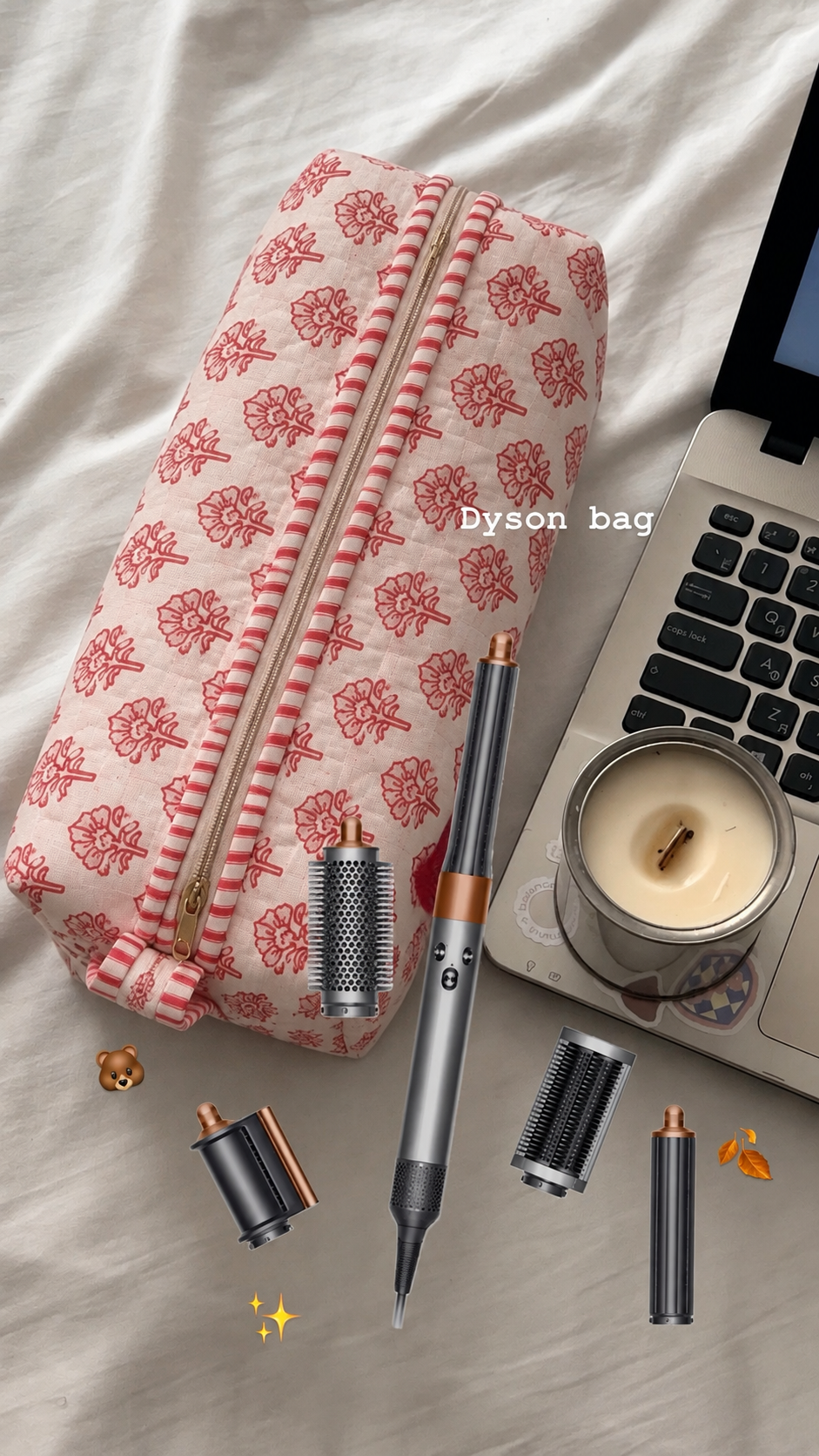 Gulaab red buti quilted hair tool bag beside a Dyson Airwrap styler and its attachments laid out on a bed