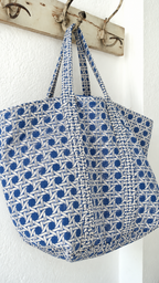 Samudra blue cane print tote hanging from a wall hook, showing its depth