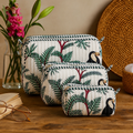 Angan quilted makeup pouch set of three in a white jungle print with toucans and palms, arranged largest to smallest