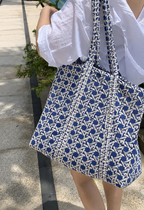 Samudra blue cane print quilted tote carried on the shoulder outdoors