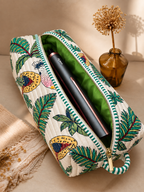 Vaan quilted hair tool bag open to show the green lining, with a hair straightener packed inside