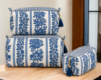 Jharna blue floral quilted pouches stacked, with blue tassels on the gold-tone zip pulls