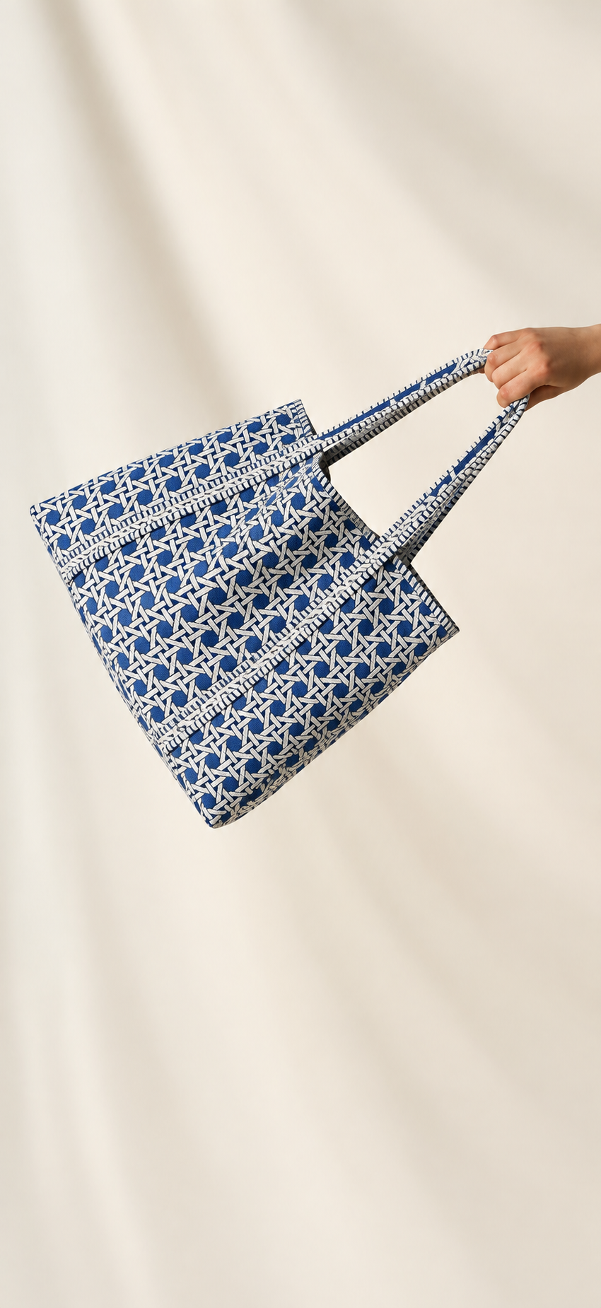 Samudra blue cane print quilted tote held out by its handles