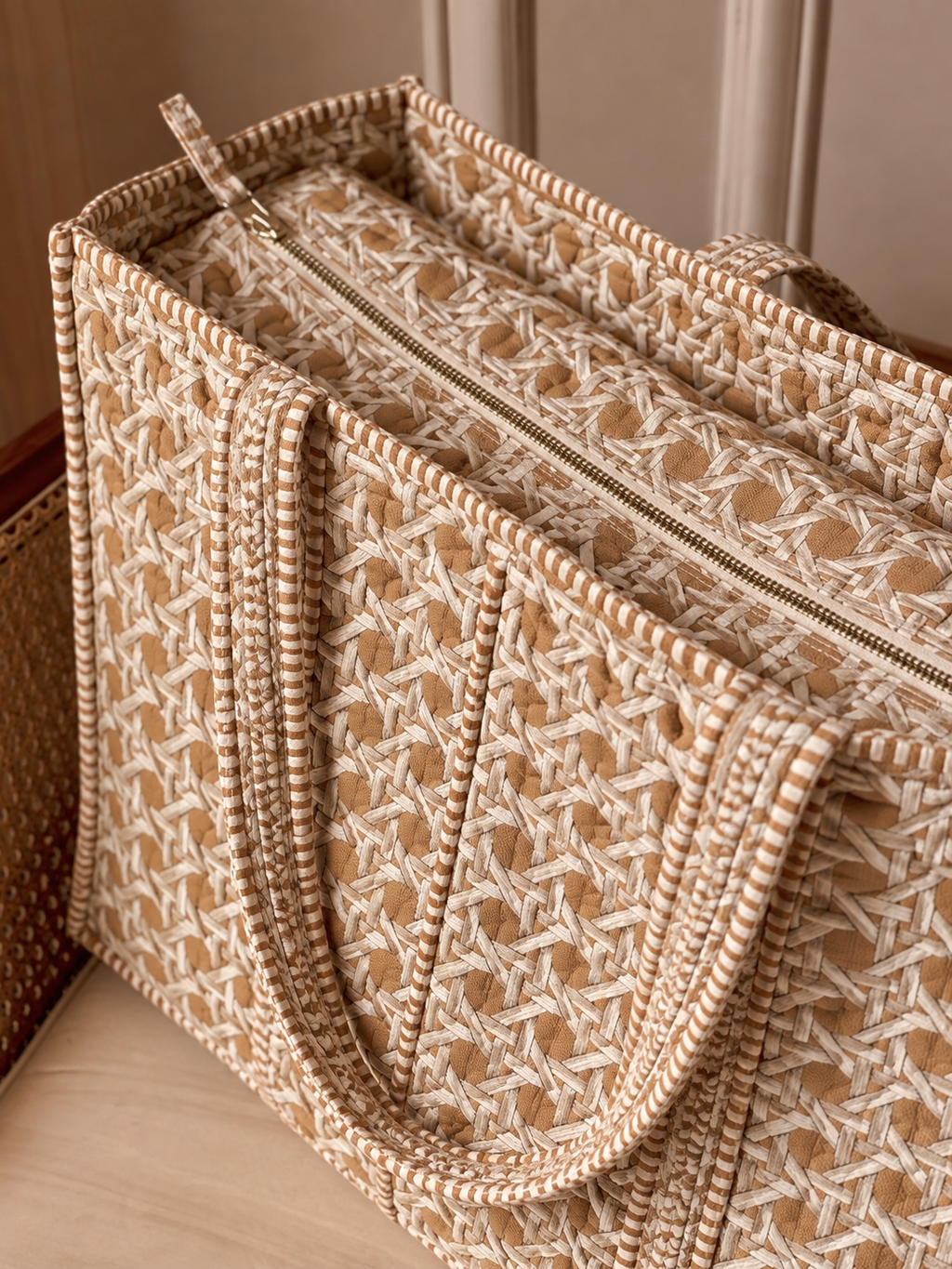 Mitti sand cane print quilted tote from above, showing the zip across the top and the striped binding