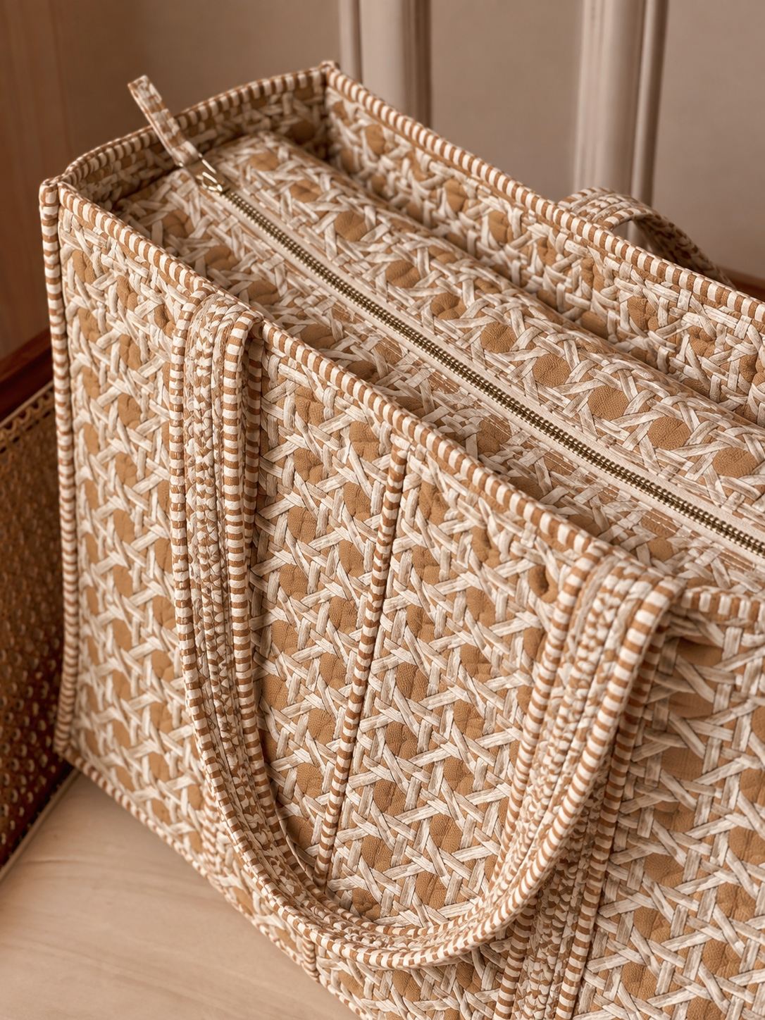 Mitti sand cane print quilted tote from above, showing the zip across the top and the striped binding