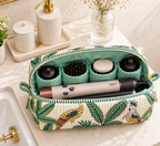 Vaan quilted hair tool bag open on a vanity, holding a Dyson Airwrap and its attachments in mint-green inner pockets