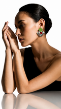Teal green Geometric Ghungroo earrings: green square stud over a white fabric diamond printed with a red flower and green leaves, edged with silver ghungroo bells, worn by a model