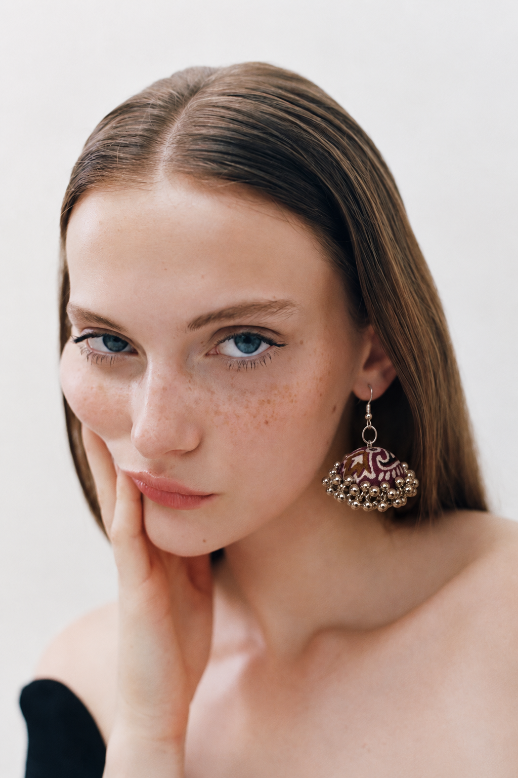 Deep maroon fabric jhumka earring with ivory floral motifs and a silver bead halo — House of Falguni