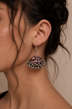 Neel Kamal jhumka against damp hair, ivory motifs clear on the maroon fabric
