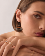 Neel Katha jhumka in soft light, dark fabric dome above clustered silver beads