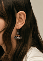Near-black fabric jhumka earring with a rust-orange scalloped edge and silver bead fringe — House of Falguni