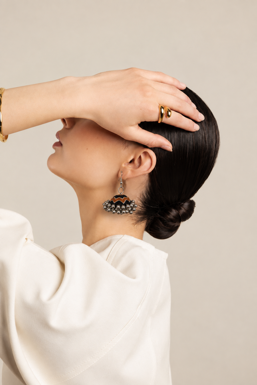 Neel Katha jhumka worn with hair gathered into a low bun and a white shirt