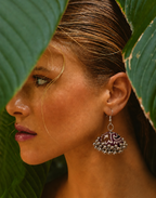 Neel Kamal jhumka in golden light with a green leaf behind