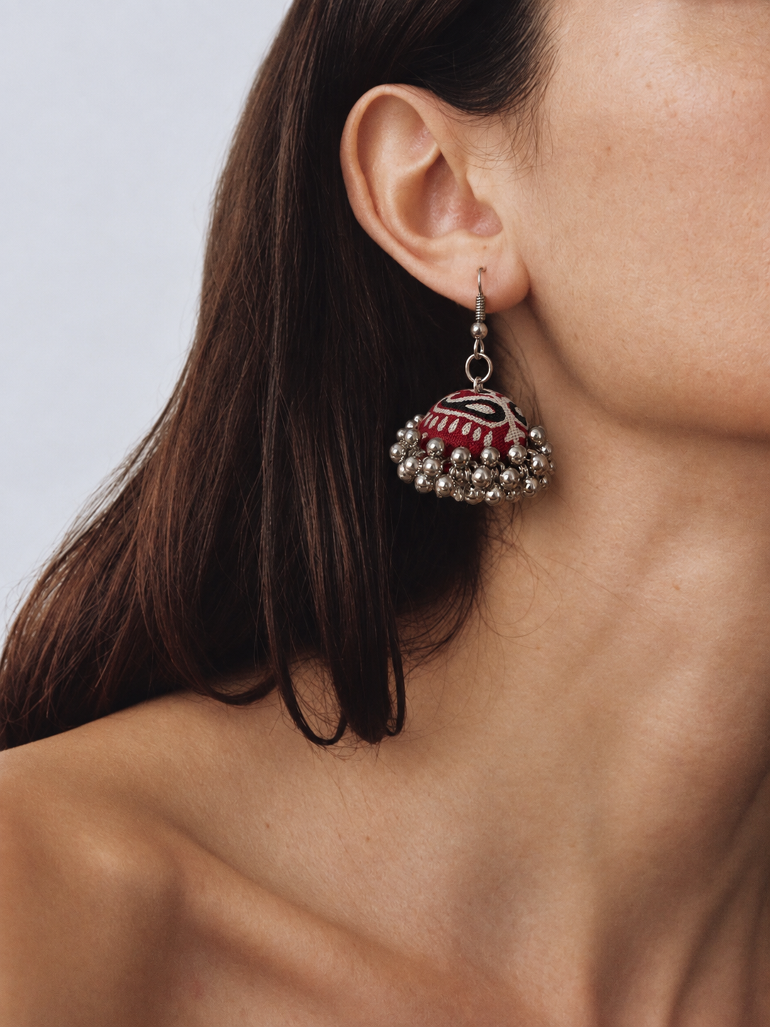 Marigold Zigzag jhumka worn with short dark hair, zigzag dome above a silver bead fringe