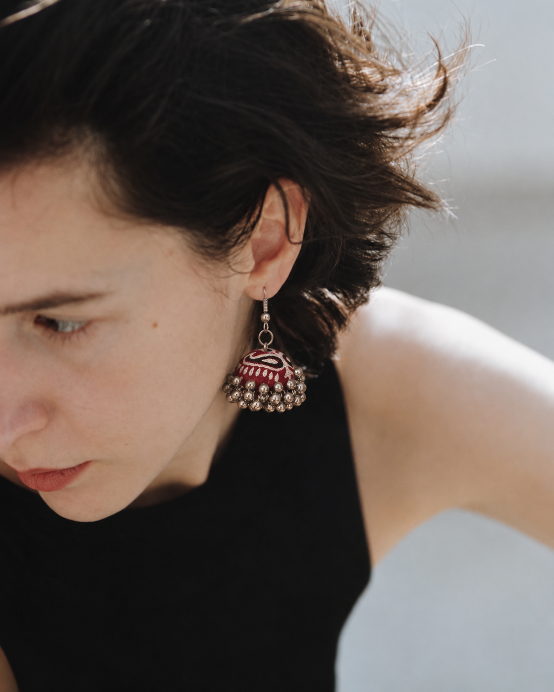 Maroon fabric jhumka earring with a pink and cream zigzag pattern — House of Falguni