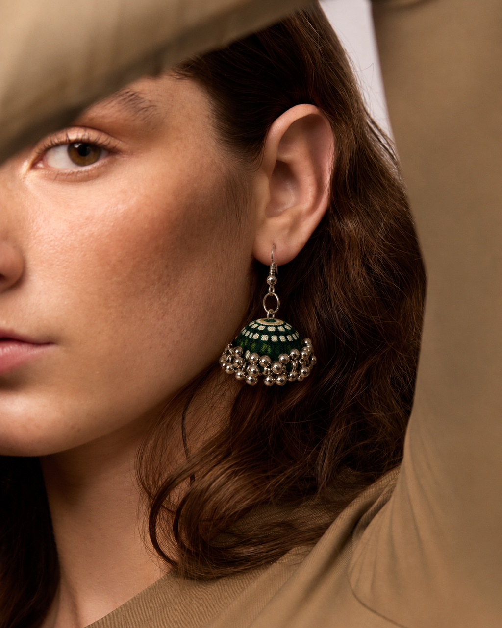 Rangrez Stripe jhumka against auburn hair, green and cream stripes running down the fabric dome