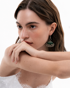 Rangrez Stripe jhumka in daylight with a white top, the striped dome resting below the ear
