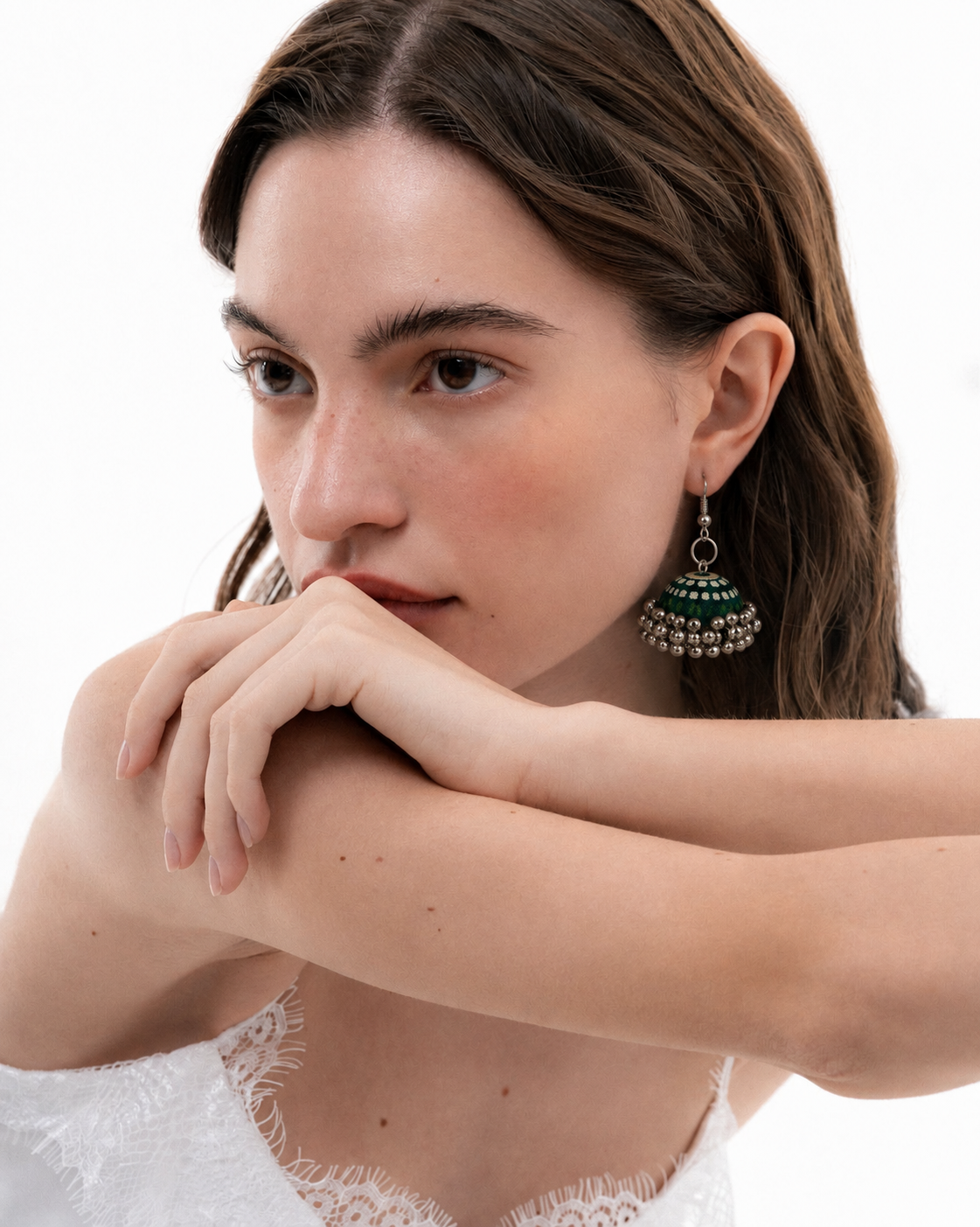 Rangrez Stripe jhumka in daylight with a white top, the striped dome resting below the ear
