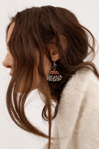 Kesari Gul jhumka worn with a cream knit, warm rust dome below the ear