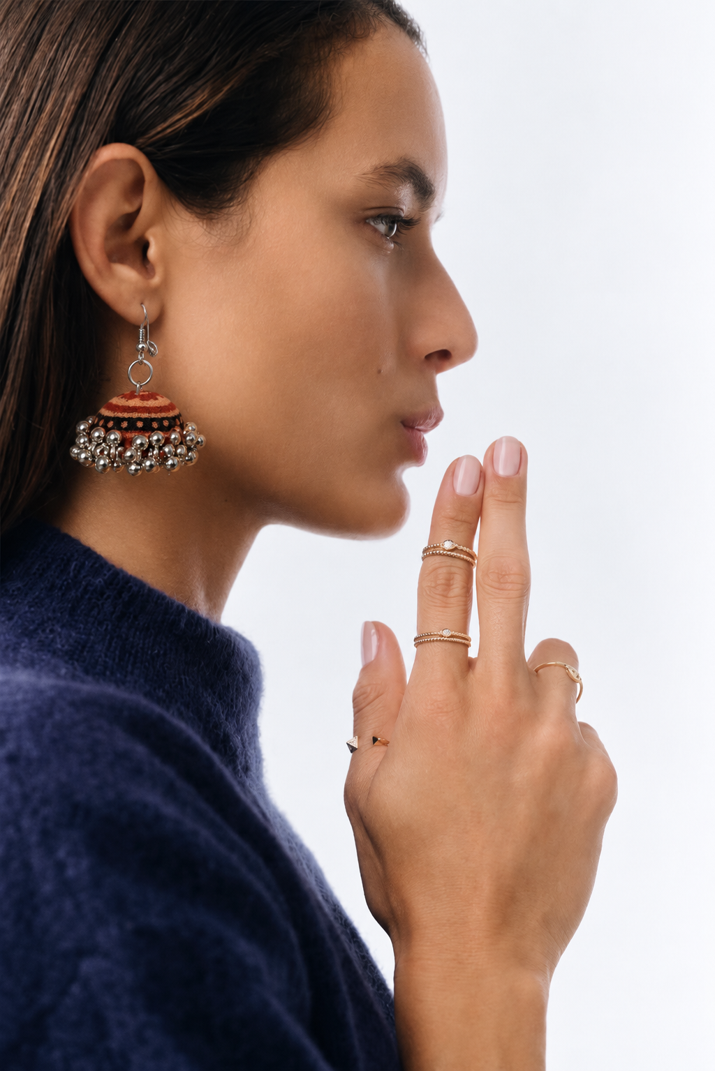 Profile wearing the Kesari Gul jhumka against a navy jumper