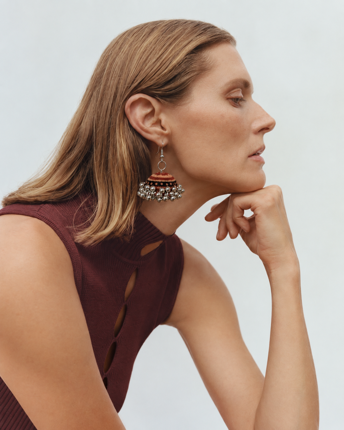 Kesari Gul jhumka worn with a burgundy sleeveless top