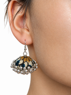 Close view of the navy and ochre-gold fabric dome on a Mehfil Green jhumka, showing the clustered silver bead fringe