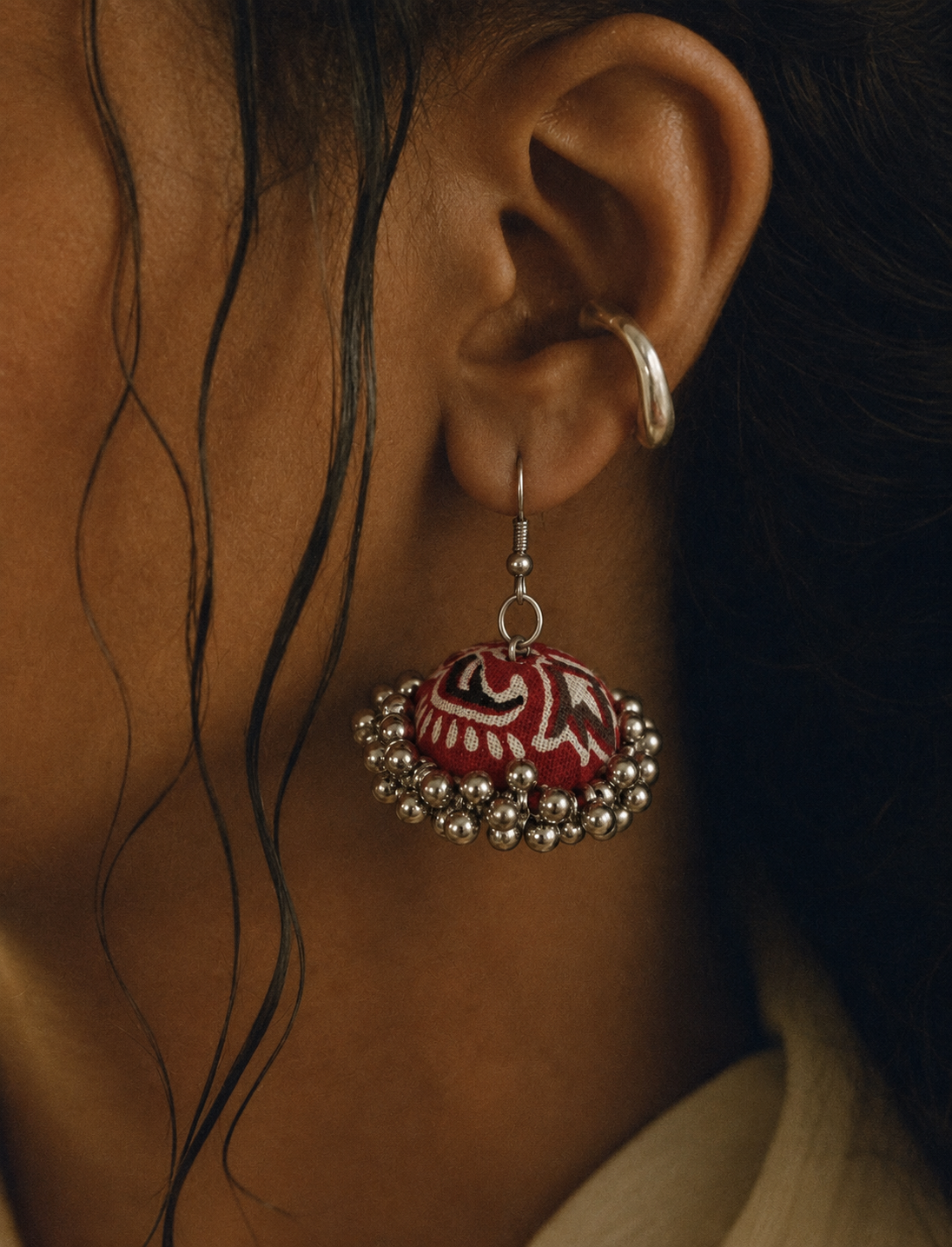 Jungle Motif jhumka worn with damp hair, red dome and cream swirls