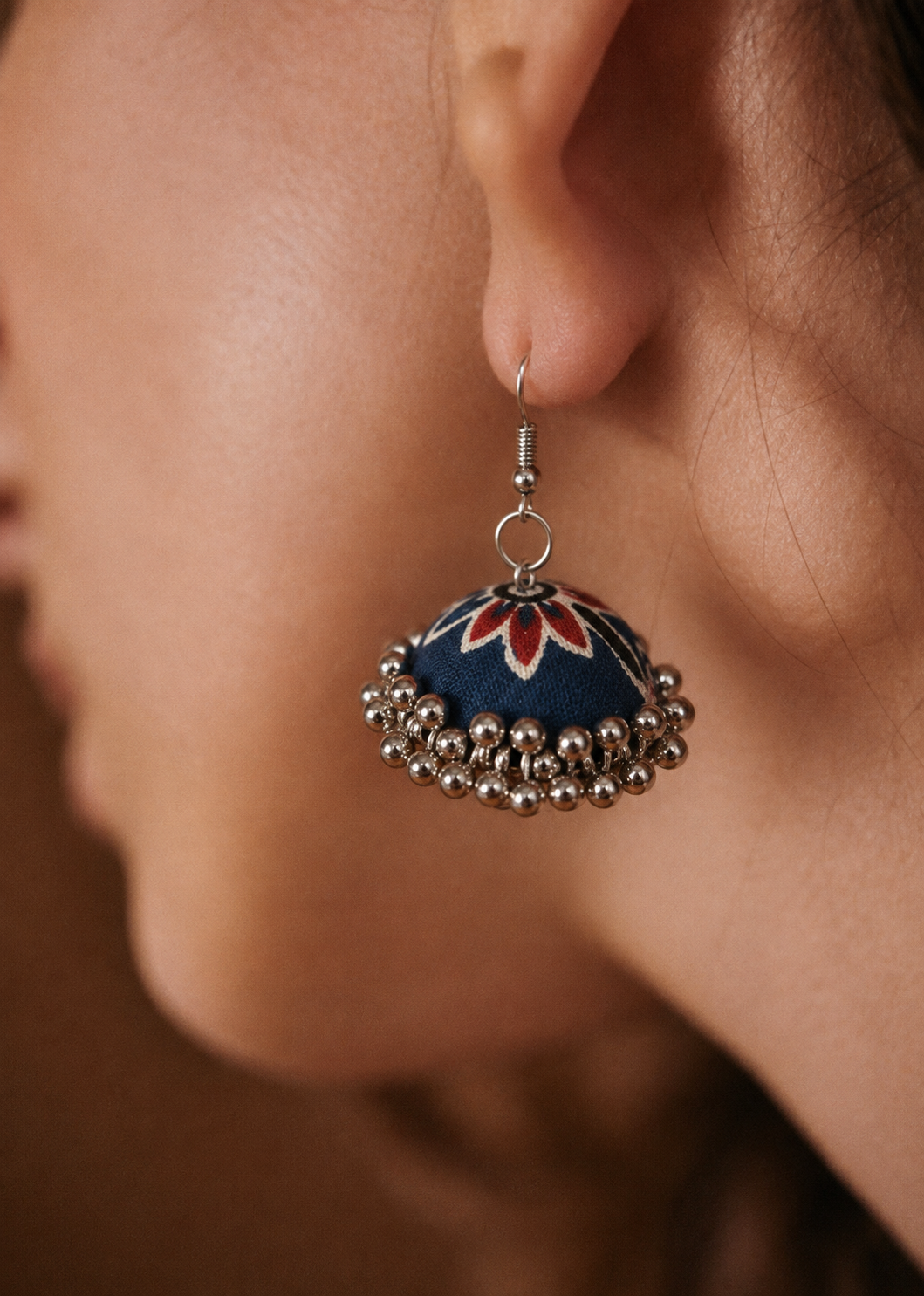 Navy fabric jhumka earring with a red lotus motif and silver bead fringe — House of Falguni