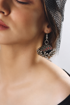 Gulabo Noir jhumka worn with a dark mesh top, silver beads resting near the shoulder