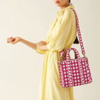 Rani pink gingham quilted mini tote worn crossbody with a yellow dress