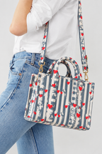 Jal grey stripe quilted mini tote worn crossbody on the long strap, with jeans and a white shirt