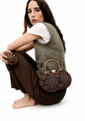 Kaali Adaa black Ajrakh block-print Mashru silk handbag with circular medallion pattern, worn on the hip, House of Falguni