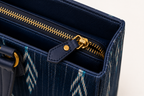 Women's handwoven ikat tote bag with metal zip and vegan leather handles, India