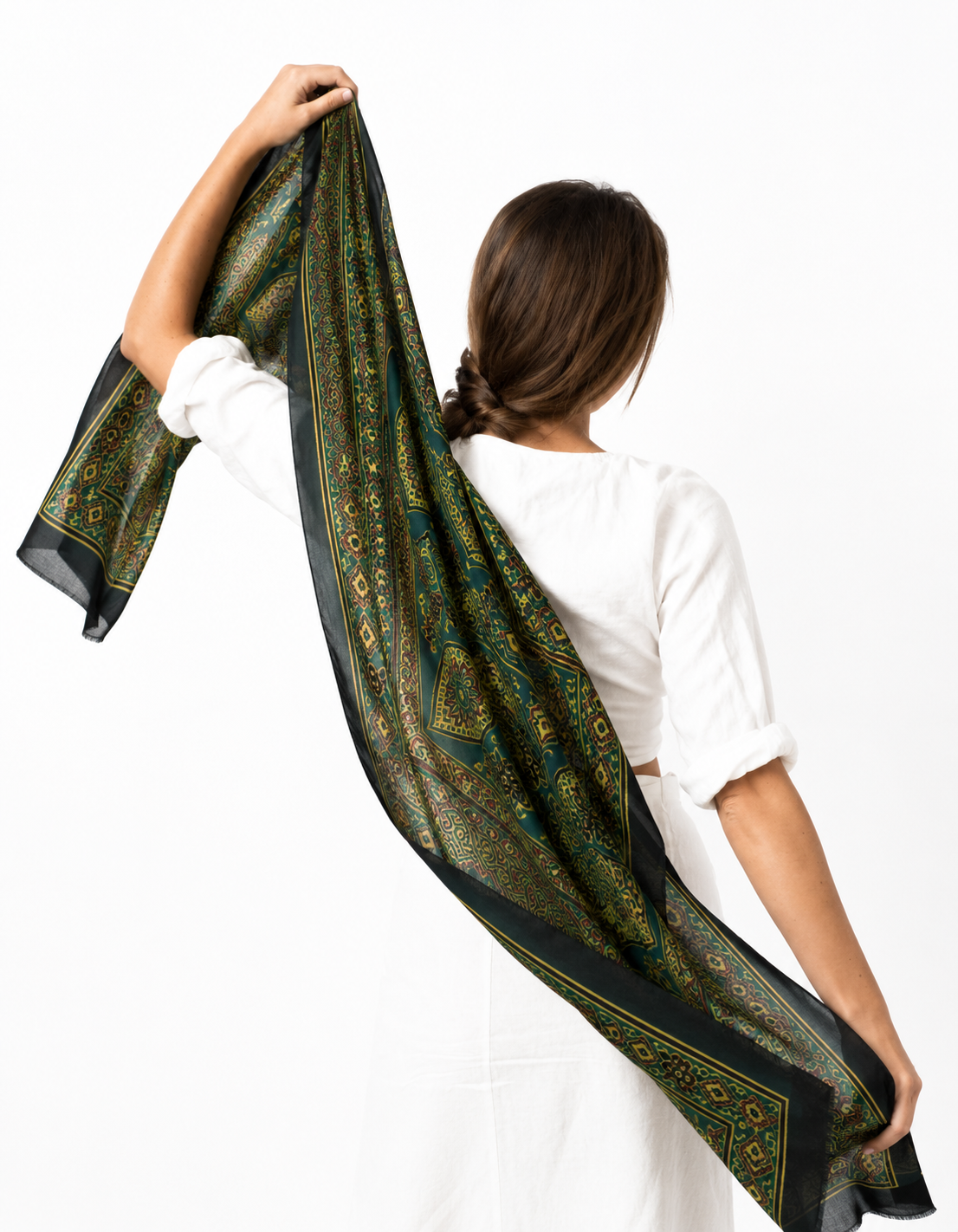 Sheesh Mahal green Ajrakh stole held up behind the shoulders to show its length and border