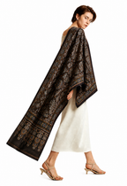 Nilufar Shahi Ajrakh black modal silk stole with cream motifs and a mustard-edged border, worn over one shoulder