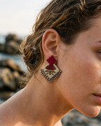 Fuchsia Floral Geometric Ghungroo Earrings worn outdoors with the hair up: fuchsia square stud over a cream floral diamond edged with ghungroo bells