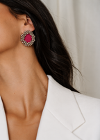 Fuchsia Pink Ghungroo Stud Earrings worn with a white blazer: fuchsia cotton centre ringed with two rows of silver-tone ghungroo bells