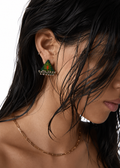 Riwaayat Morni dark green triangle earrings: dark green fabric block-printed with a red and yellow motif and a row of ghungroo bells, worn on the ear