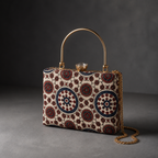 Aaina ivory and blue circular-print Mashru silk handbag in charcoal studio, with gold-tone top handle and detachable chain