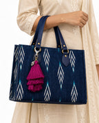 Jamuni silk tassel charm clipped to the Midnight Ikat Laptop Tote Bag, Navy