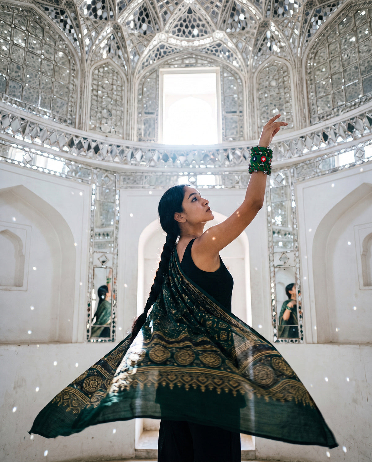 Sheesh Mahal green Ajrakh modal silk stole swirling in a mirror-work hall, worn with green mirror-work bangles
